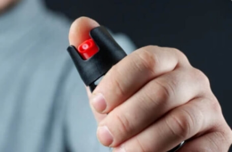 hand holding a can of pepper spray